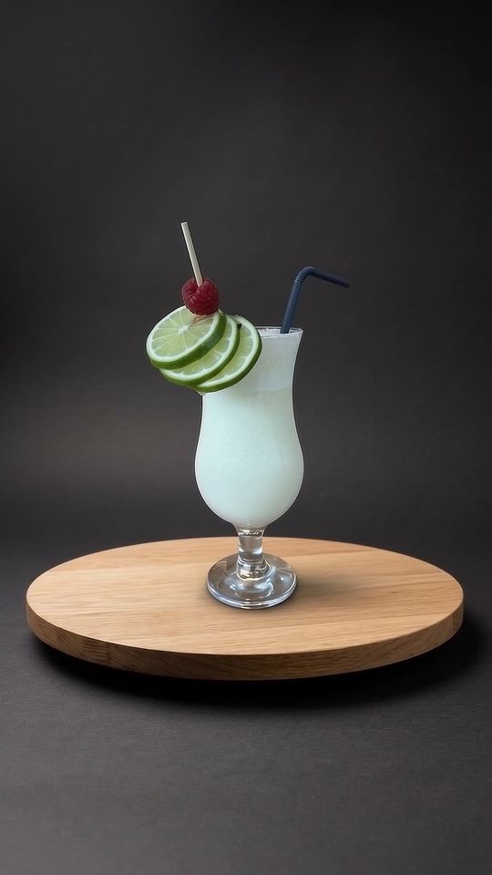 Pina Colada auf einer Eichenplatte vor dunklem Hintergrund